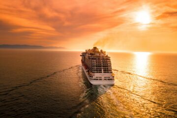 cruise ship sailing into sunset
